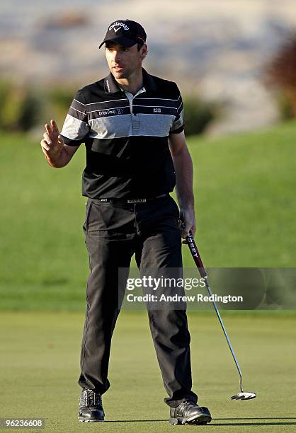 Oliver Wilson of England acknowledges the crowd on the 17th hole during the first round of the Commercialbank Qatar Masters at Doha Golf Club on...