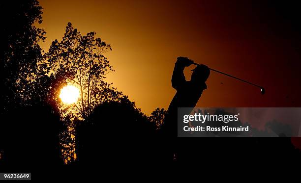 Paul Casey of England watches his second shot in to the par five 18th hole as the sun sets at the end of the first round of The Commercialbank Qatar...