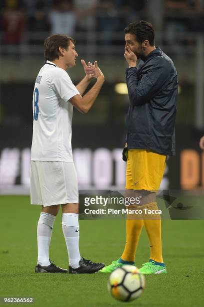 Leonardo Nascimento de Araujo and Gigi Buffon speak during Andrea Pirlo Farewell Match at Stadio Giuseppe Meazza on May 21, 2018 in Milan, Italy.