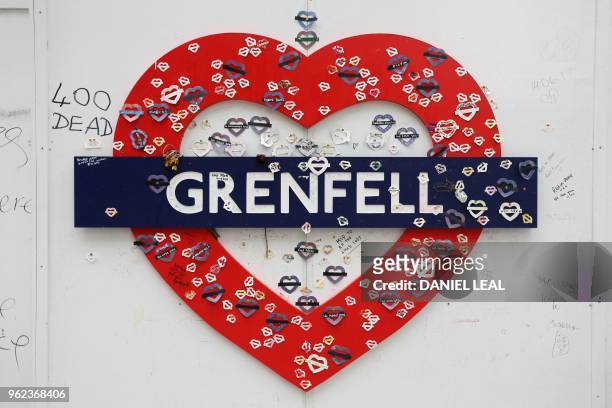 Messages of condolence for the victims of the Grenfell Tower fire are pictured on a fence near to the burned-out shell of Grenfell Tower block in...