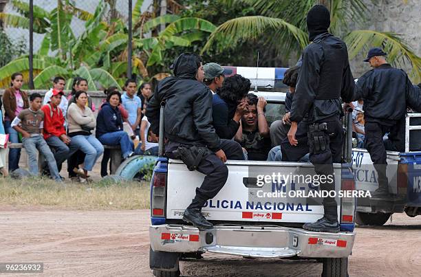 Policeman capture youngsters during a security operation in which arms including an RPG-7 grenade launcher were seized in the outskirts of...