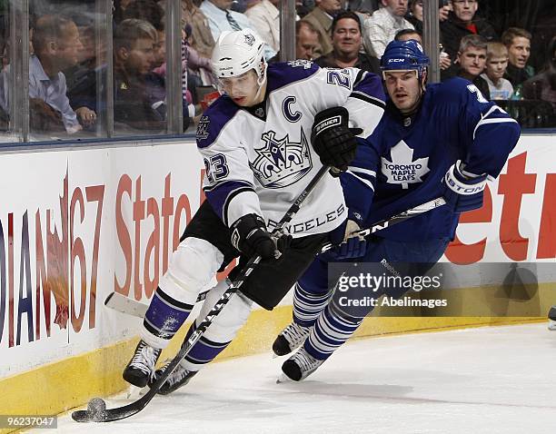 Ian White of the Toronto Maple Leafs tracks Dustin Brown of the Los Angeles Kings during the game on January 26, 2010 at the Air Canada Centre in...