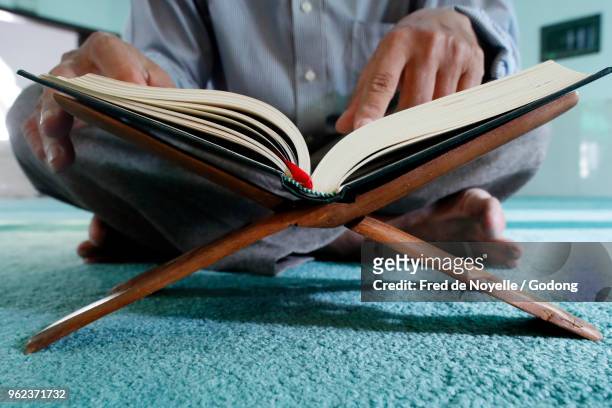 masjid al rahim mosque. imam reading the holy quran. ho chi minh city. vietnam. - imam stock pictures, royalty-free photos & images