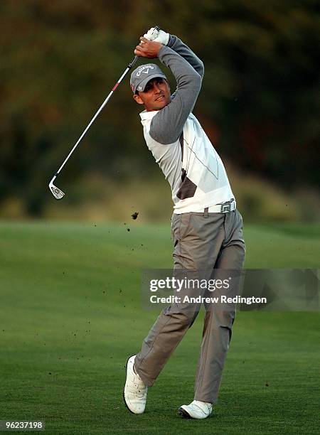 Niclas Fasth of Sweden hits his second shot on the 18th hole during the first round of the Commercialbank Qatar Masters at Doha Golf Club on January...