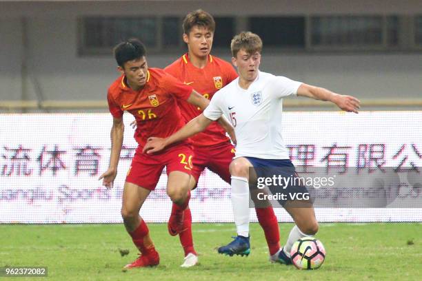 Callum Wright of England U19 National Team and Chen Ao of China U19 National Team compete for the ball during the 2018 Panda Cup International Youth...