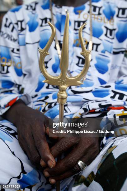 voodoo shrine in cotonou, benin. man holding a trident. - animism stock pictures, royalty-free photos & images