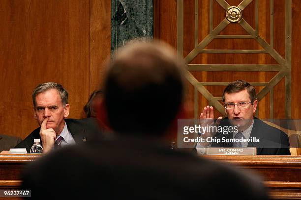 Senate Budget committee ranking member Sen. Judd Gregg listens as committee Chairman Kent Conrad questions Congressional Budget Office Director...