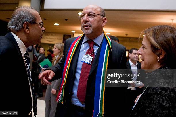 Trevor Manuel, minister of South Africa's National Planning Commission , center, speaks with Prakash P. Hinduja of the Hinduja Group of Companies,...