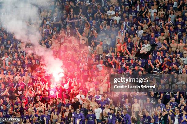 Ultra fans of Ujpest FC light torches and make smoke during the Hungarian Cup Final match between Puskas Akademia FC and Ujpest FC at Groupama Arena...