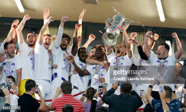 Robert Litauszki of Ujpest FC lifts up the cup among teammates during the Hungarian Cup Final match between Puskas Akademia FC and Ujpest FC at...