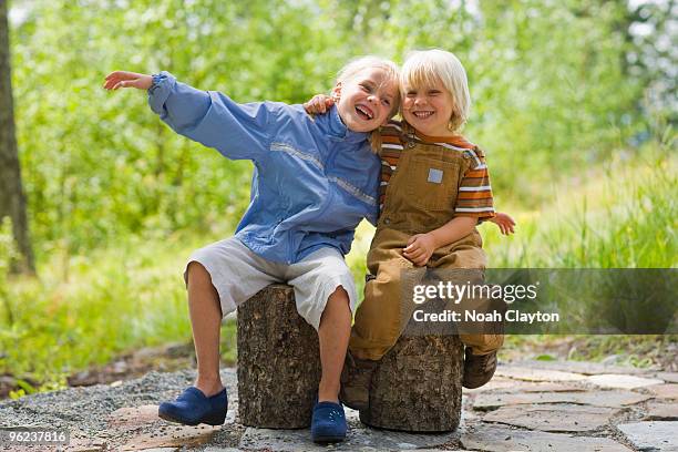 brother and sister embracing and smiling - seven stones stock pictures, royalty-free photos & images