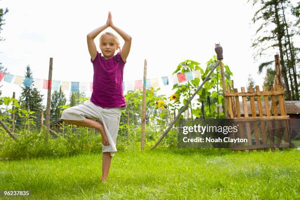 girl doing yoga in backyard. - girl yoga stock pictures, royalty-free photos & images