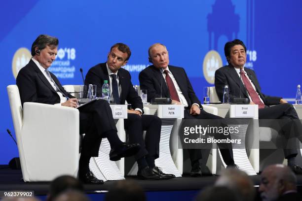 From left to right, John Micklethwait, editor-in-chief at Bloomberg News, Emmanuel Macron, France's president, Vladimir Putin, Russia's president,...