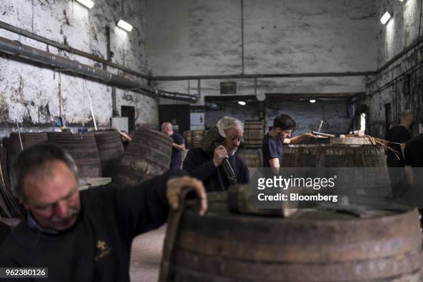 Coopers assemble wine barrels ahead of the grape harvest season and port production at the Symington-Family Estates Vinhos Lda vineyard in the Douro...