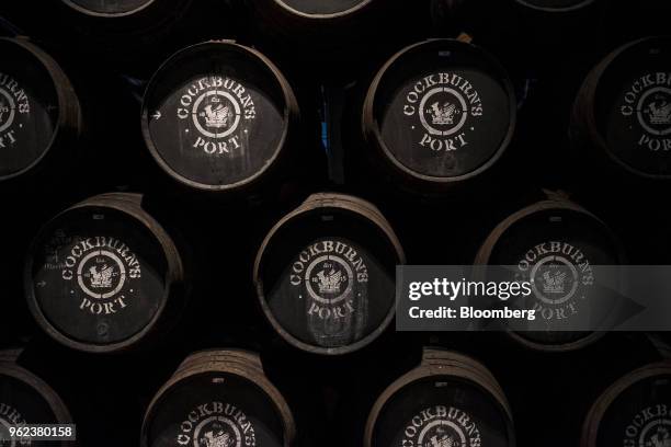 Barrels of Cockburn's Port sit stacked in the cellars at the Symington-Family Estates Vinhos Lda vineyard in the Douro Valley region in Gaia,...