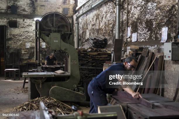 Coopers work on wine barrel staves in a workshop ahead of the grape harvest season and port production at the Symington-Family Estates Vinhos Lda...