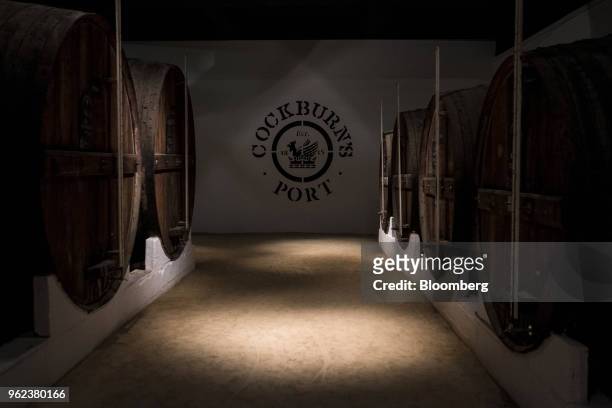 Barrels of Cockburn's Port sit stacked in the cellars at the Symington-Family Estates Vinhos Lda vineyard in the Douro Valley region in Gaia,...