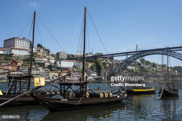 Barrels sit onboard traditional wooden Rabelos cargo boats on the Douro River in Porto, Portugal, on Monday, May 21, 2018. Portugal's gross domestic...