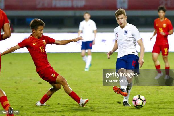 Alex Denny of England U19 National Team and Sun Qinhan of China U19 National Team compete for the ball during the 2018 Panda Cup International Youth...