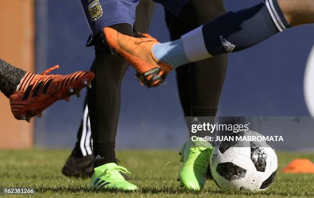 Argentina's national football team forward Lionel Messi , passes the ball during a training session in Ezeiza, Buenos Aires on May 25, 2018. - The...