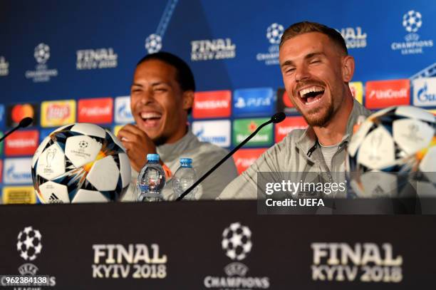 In this handout image provided by UEFA Virgil van Dijk and Jordan Henderson of Liverpool laugh during a Liverpool press conference ahead of the UEFA...