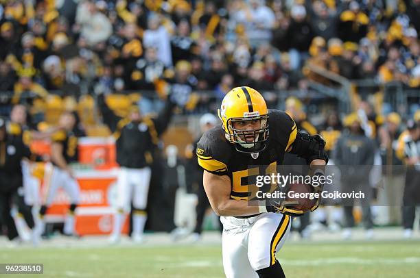 Linebacker James Farrior of the Pittsburgh Steelers runs with the football after intercepting a pass thrown by quarterback Joe Flacco of the...