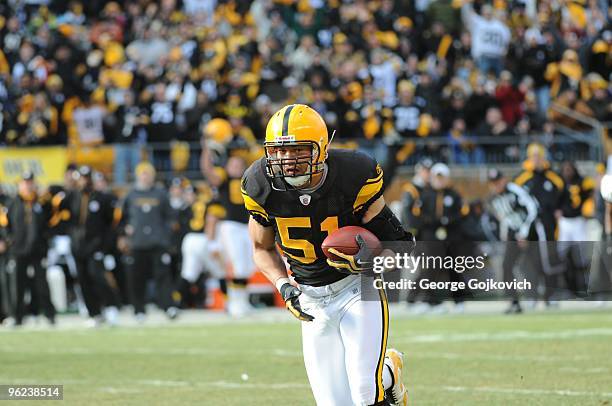 Linebacker James Farrior of the Pittsburgh Steelers runs with the football after intercepting a pass thrown by quarterback Joe Flacco of the...