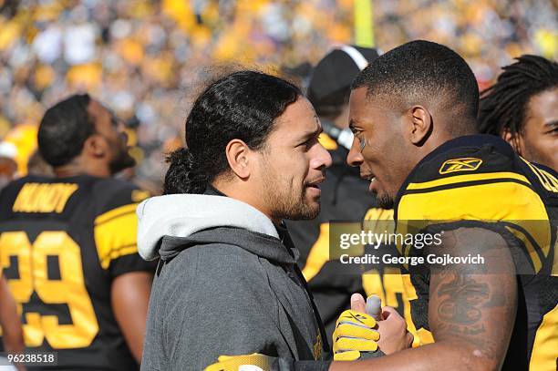 Injured safety Troy Polamalu of the Pittsburgh Steelers talks with teammate Ryan Clark on the sideline during a game against the Baltimore Ravens at...