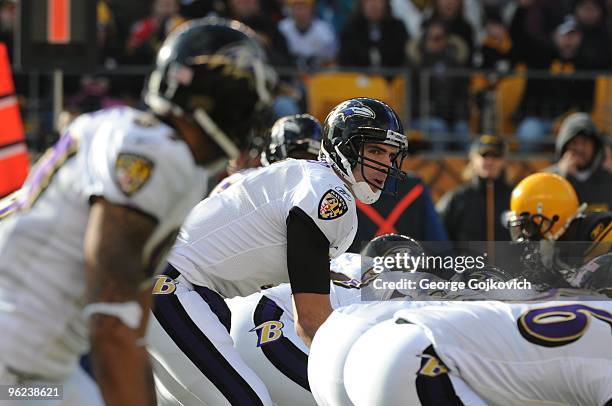 Quarterback Joe Flacco of the Baltimore Ravens looks up as he stands behind center at the line of scrimmage during a game against the Pittsburgh...