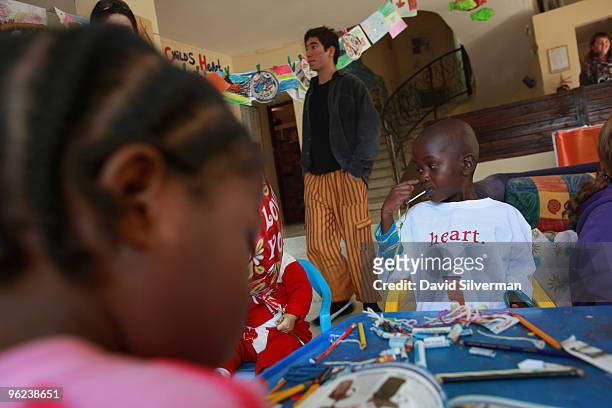Haitian boy Woodley Elysee takes in his new surroundings at the Save A Child's Heart home shortly after his arrival on January 28, 2010 in Azur, near...