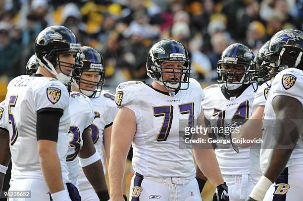 Center Matt Birk and quarterback Joe Flacco of the Baltimore Ravens look on from the huddle during a game against the Pittsburgh Steelers at Heinz...