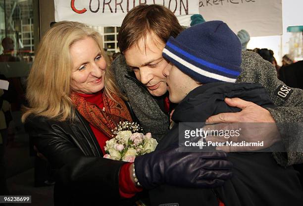 Dr Andrew Wakefield and his wife Carmel are given a hug by 17 year old Josh Edwards, who is autistic, outside the General Medical Council on January...