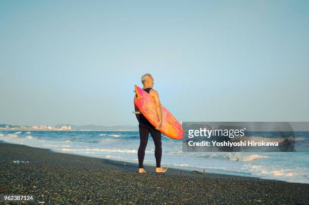 senior surfer at beach - chigasaki stock pictures, royalty-free photos & images