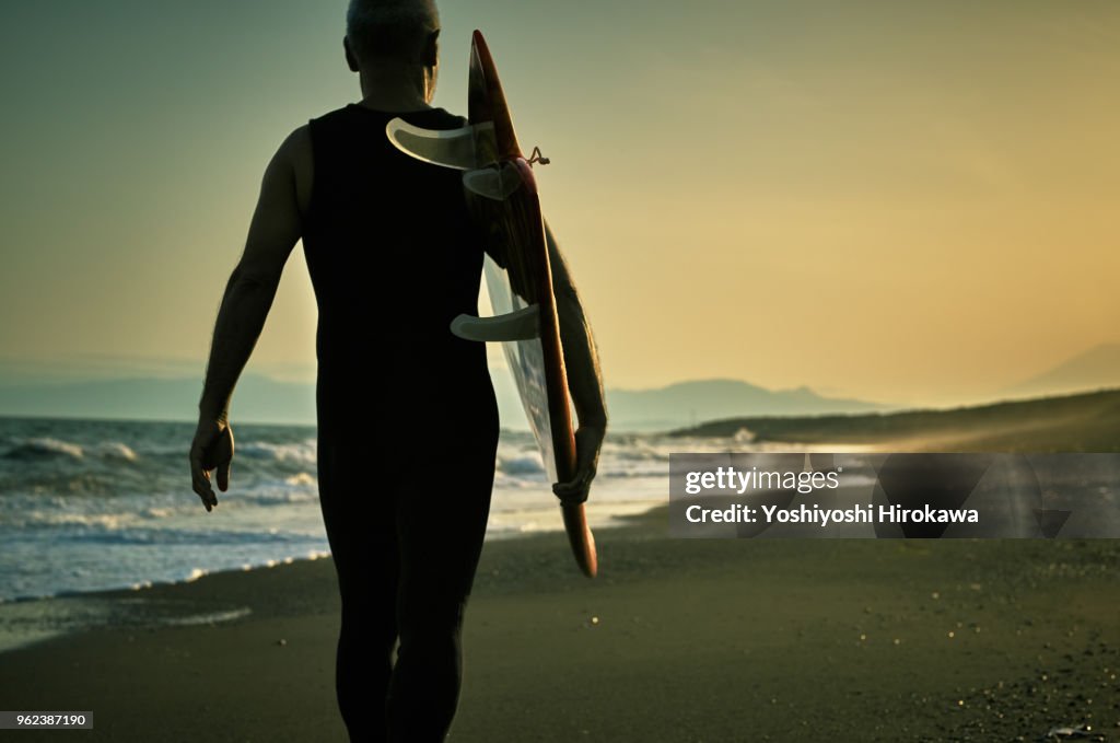 Silhouette of Senior surfer