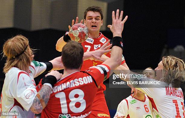 Norway defenders vie with Arnor Atlason of Iceland, in Vienna on 28 January, 2010 during their second round game of EHF EURO 2010 Championship....