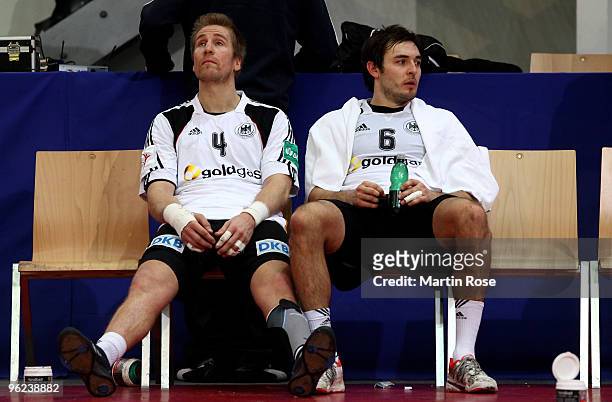Oliver Roggisch and Michael Mueller of Germany look dejected after the Men's Handball European main round Group II match between Germany and Czech...