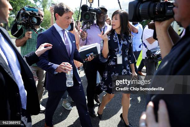 White House Deputy Press Secretary Hogan Gidley is surrounded by reporters and camera operators as he walks back into the White House following a...