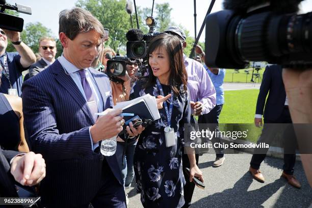 White House Deputy Press Secretary Hogan Gidley is surrounded by reporters and camera operators as he walks back into the White House following a...