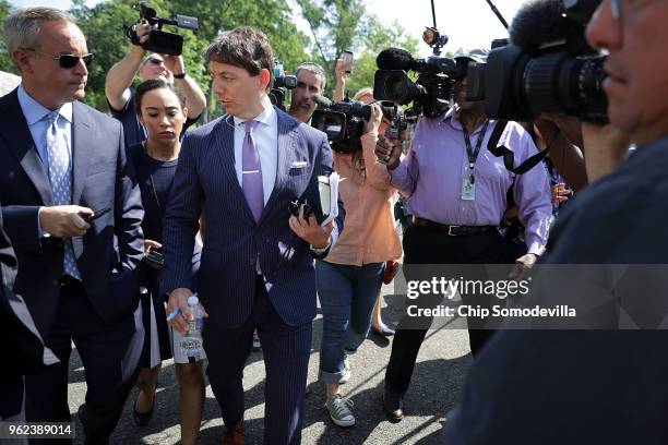 White House Deputy Press Secretary Hogan Gidley is surrounded by reporters and camera operators as he walks back into the White House following a...