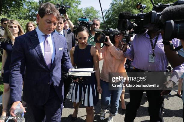 White House Deputy Press Secretary Hogan Gidley is surrounded by reporters and camera operators as he walks back into the White House following a...