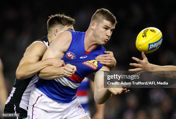 Billy Gowers of the Bulldogs is tackled by Josh Thomas of the Magpies during the 2018 AFL round 10 match between the Collingwood Magpies and the...