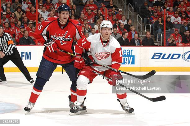 Daniel Cleary of the Detroit Red Wings looks for a pass with presure from Jeff Schultz of the Washington Capitals during a NHL hockey game on January...