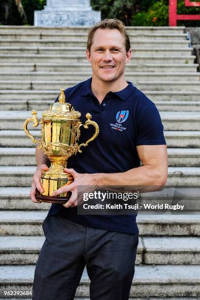 England's Rugby World Cup 2003 winner Josh Lewsey poses for a photo with the Webb Ellis Cup at Confucius Hall Secondary School during the Rugby World...