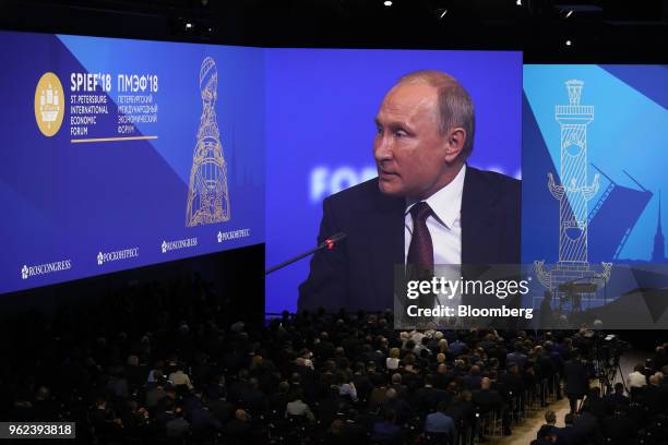 Vladimir Putin, Russia's president, speaks on screen during a panel discussion during the plenary session at the St. Petersburg International...