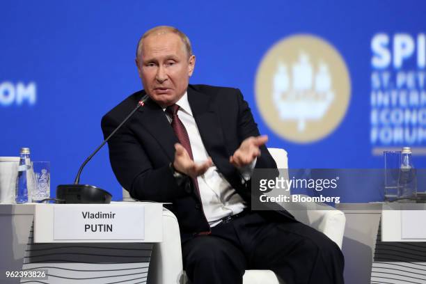 Vladimir Putin, Russia's president, gestures as he speaks during a panel discussion during the plenary session at the St. Petersburg International...