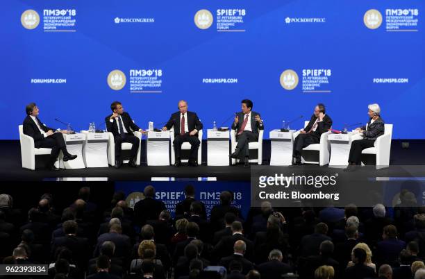 From left to right, John Micklethwait, editor-in-chief at Bloomberg News, Emmanuel Macron, France's president, Vladimir Putin, Russia's president,...