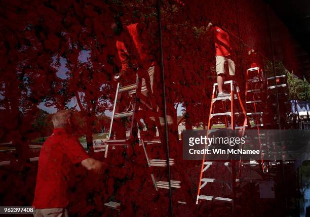 Workers put the final touches on an installation of a temporary pop-up 'Poppy Memorial' on the national mall near the Lincoln Memorial in advance of...