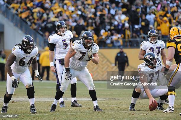 Offensive linemen Oniel Cousins and Marshal Yanda and quarterback Joe Flacco of the Baltimore Ravens look across the line of scrimmage during a game...