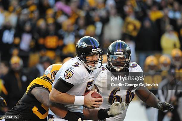 Defensive lineman Ziggy Hood of the Pittsburgh Steelers sacks quarterback Joe Flacco of the Baltimore Ravens as offensive lineman Ben Grubbs looks on...