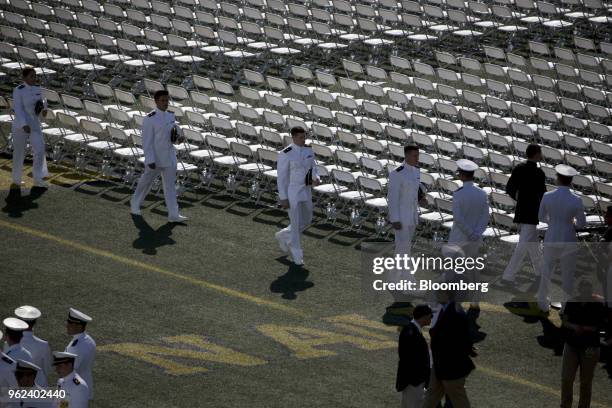 Graduating midshipmen arrive during the United States Naval Academy graduation and commissioning ceremony at the Navy-Marine Corps Memorial Stadium...